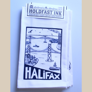 a photo of a white tea towel with an image of Halifax Harbour including both bridges, the Tufts Cove smoke stacks and the Dartmouth Ferry